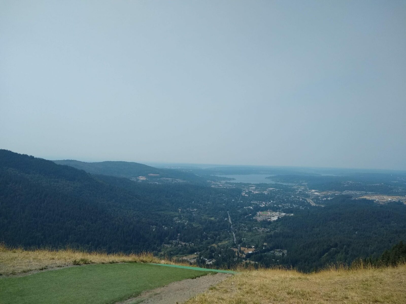 a view overlooking a valley with a lake and a town