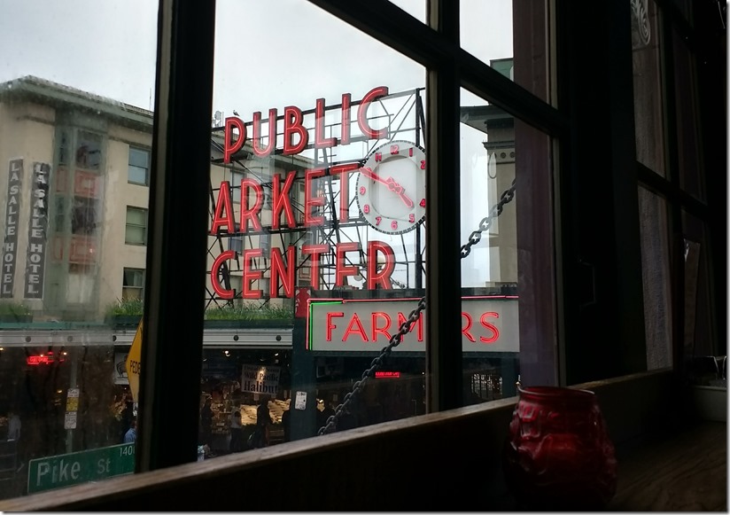 Public Market Center Sign and a clock and buildings on an overcast day