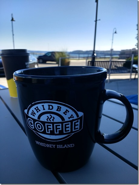 A coffee mug on a shaded outdoor table