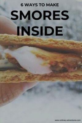 A two graham crackers with melted chocolate and marshmellow in between against a background of snow