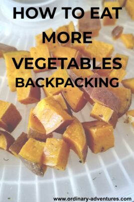 Cubed sweet potatoes on a tray. Text reads: How to eat more vegetables backpacking