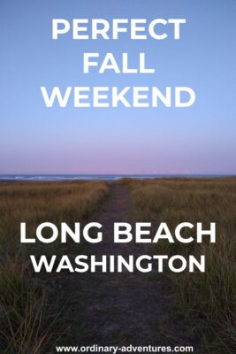 A path through the tall grasses to the beach on the Pacific Ocean at Long Beach, Washington. The ocean is visible in the distance at dawn. Text reads: Perfect Fall weekend Long Beach Washington