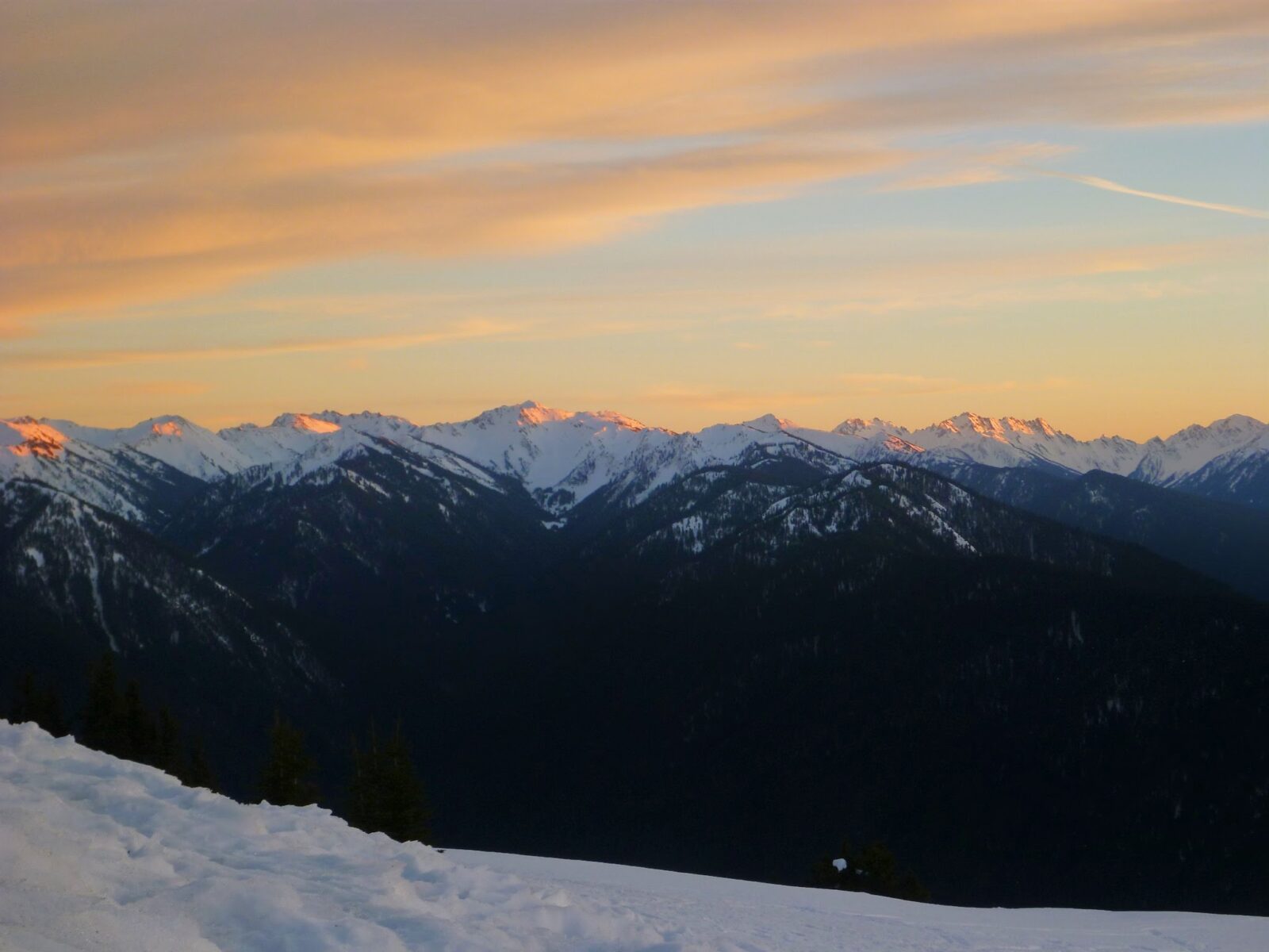 Last bit of pink sunset lingers on the mountains of from Hurricane Ridge, a favorite day trip from Seattle