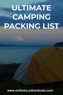 A yellow and white tent just after sunset near a beach with a high mountain in the background in alpenglow. Text reads: ultimate camping packing list