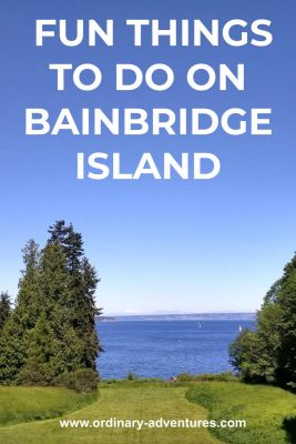 Blue water with sailboats in the distance and several trees and a green lawn in the foreground. Text reads: fun things to do on bainbridge island