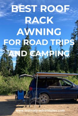 A blue suv with a roof rack awning and the hatch open on a sunny day in the forest. Text reads: best roof rack awning for road trips and camping